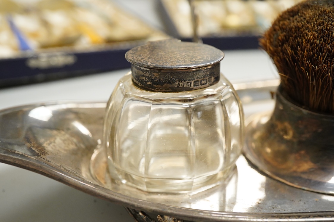 An Edwardian silver elliptical shaped inkstand, with two mounted glass wells and central pen wipe, James Dixon & Sons, Sheffield, 1906, together with ten Danish sterling and polychrome enamel spoons(a.f) and a cased set